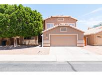 Two-story home with manicured landscaping, a two-car garage, and a well-maintained lawn at 113 N Albert Dr, Chandler, AZ 85226