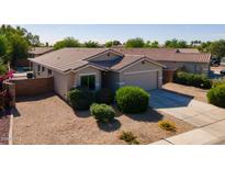 Charming single-story home featuring a tile roof, low-maintenance landscaping, and an attached two-car garage at 13170 W Clarendon Ave, Litchfield Park, AZ 85340