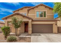 Charming two-story home featuring a well-manicured front yard, covered porch, and attached two-car garage at 15551 W Poinsettia Dr, Surprise, AZ 85379