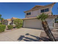 Inviting two-story home featuring a tile roof, two-car garage, and desert landscaping under a bright blue sky at 1610 W Maplewood St, Chandler, AZ 85286