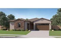 Charming single-story home featuring a stone facade, two-car garage, and well-manicured lawn at 16933 W Bronco Trl, Surprise, AZ 85387