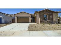 Charming single-story home featuring a two-car garage, desert landscaping, and a welcoming entrance at 16933 W Bronco Trl, Surprise, AZ 85387