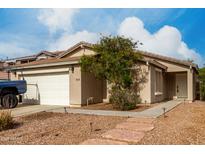 Charming single-story home featuring a well-maintained yard with desert landscaping and a two car garage at 4038 E Wrangler Ct, Gilbert, AZ 85297