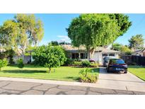 Charming single-story home featuring a well-manicured lawn and mature landscaping at 4139 E Edgemont Ave, Phoenix, AZ 85008