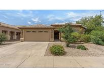 Charming home featuring a two-car garage, desert landscaping, and a neutral color palette at 4404 W Ellis St, Laveen, AZ 85339