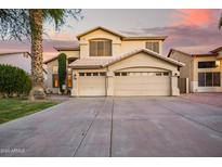 Elegant two-story home featuring a spacious three-car garage and meticulously maintained landscaping at 521 N Cambridge St, Gilbert, AZ 85233
