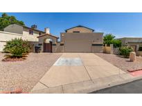 Charming home with a well-maintained front yard and a two-car garage at 619 E Jensen St # 34, Mesa, AZ 85203