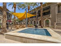 Inviting community pool area with lounge seating, grilling stations and shade, perfect for outdoor relaxation at 6565 E Thomas Rd # 1096, Scottsdale, AZ 85251