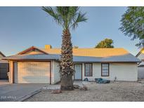 Charming single-story home featuring a low maintenance desert front yard, palm tree, and attached garage at 7222 W Maryland Ave, Glendale, AZ 85303