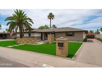 Inviting single story home with lush lawn, mature trees, and neutral tones with excellent curb appeal at 8214 E Northland Dr, Scottsdale, AZ 85251