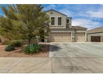 Charming home with a three-car garage, desert landscaping, and a spacious driveway at 887 W Santa Gertrudis Trl, San Tan Valley, AZ 85143
