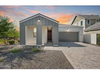 Charming single-story home featuring a gray exterior, covered porch, and brick driveway at 2324 E Marguerite Ave, Phoenix, AZ 85040