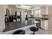 Bright kitchen features modern appliances, breakfast bar, and ample cabinet space at 2455 E Broadway Rd # 115, Mesa, AZ 85204