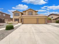Charming two-story home boasts a three-car garage and manicured landscaping at 31670 N Desert Willow Rd, San Tan Valley, AZ 85143