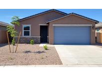 Charming single-story home with a desert landscape and a gray two-car garage door at 3529 E Audrey Dr, San Tan Valley, AZ 85143