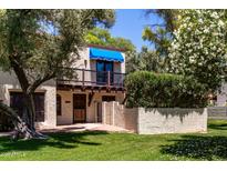Charming two-story home with a balcony and a well-manicured lawn and beautiful, mature landscaping at 4812 E Winston Dr # 2, Phoenix, AZ 85044