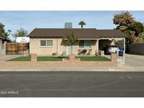Charming home with manicured lawn, carport, and inviting curb appeal at 538 E Glade Ave, Mesa, AZ 85204