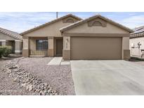 Charming single-story home with desert landscaping and a two-car garage, offering curb appeal at 6410 W Winslow Ave, Phoenix, AZ 85043