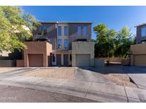 Charming townhome featuring a neutral palette, attached garages, and private entrances in a well-kept community at 827 E Pecan Rd, Phoenix, AZ 85040