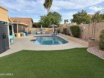Beautiful backyard pool and patio area with manicured landscaping and lounge seating at 9004 S Ash Ave, Tempe, AZ 85284