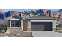 Charming single-story home showcasing desert landscaping, a two-car garage and shutters at 10516 W Bloch Rd, Tolleson, AZ 85353