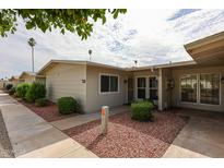 Charming single-story home featuring desert landscaping and a cozy covered entry at 10827 W Santa Fe Dr, Sun City, AZ 85351