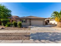 Charming single-story home with a well-maintained front yard and two-car garage at 11402 W Hadley St, Avondale, AZ 85323