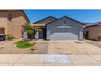 Charming single-story home features a two-car garage, desert landscaping, and mature palm trees at 11538 W Windrose Ave, El Mirage, AZ 85335