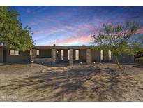 Charming single-story home with stone accents, desert landscaping, and walkway leading to the front entrance at 12423 N 64Th St, Scottsdale, AZ 85254