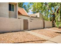 Charming home with a red tile roof, gated entry, and neutral-toned stucco walls surrounded by gravel landscaping at 1342 W Emerald Ave # 286, Mesa, AZ 85202