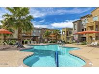 Resort-style community pool with lounge seating and palm trees, perfect for relaxation and enjoyment at 2150 W Alameda Rd # 1313, Phoenix, AZ 85085