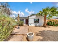 Charming single-story home featuring a red-accented entry, mature landscaping and a beautiful palm tree at 2801 N 10Th St, Phoenix, AZ 85006