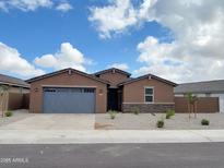 Charming single-story home with a gray garage door and desert landscaping at 37114 W La Paz St, Maricopa, AZ 85138