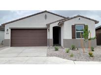 Charming single-story home featuring a well-manicured yard and a two-car garage with neutral color palette at 37154 W Prado St, Maricopa, AZ 85138