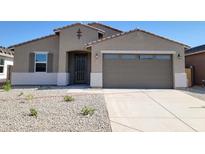 Charming single-story home features a well-kept front yard and a convenient two-car garage, offering comfort and style at 37414 W San Sisto Ave, Maricopa, AZ 85138