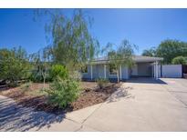 Charming single-story home featuring a well-maintained front yard and a long driveway at 3841 N 21St Ave, Phoenix, AZ 85015