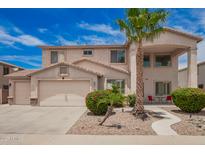 Charming two-story home boasts a well-manicured front yard, two-car garage, and a welcoming front porch at 43228 W Knauss Dr, Maricopa, AZ 85138