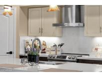 Bright kitchen featuring stainless steel appliances, light countertops, and cream colored cabinets at 508 W San Angelo St, Gilbert, AZ 85233