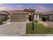 Charming home featuring a well-manicured lawn, neutral color palette, and a spacious two-car garage at 512 W Encinas St, Gilbert, AZ 85233