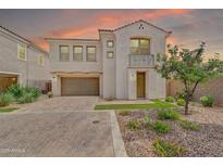 Charming two-story home features a landscaped front yard and a private balcony above the entry at 717 N Abalone Ct, Gilbert, AZ 85233