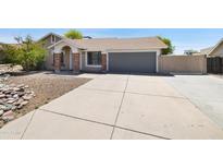 Charming single-story home with well-maintained landscaping and a two-car garage at 7337 E Ivyglen St, Mesa, AZ 85207