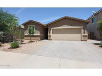 Charming single-story home with a two-car garage and a well-maintained front yard at 7648 W Kerby Ave, Phoenix, AZ 85043