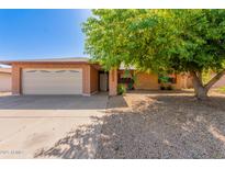 Charming single-story brick home with a two-car garage and a mature shade tree at 10032 N 50Th Dr, Glendale, AZ 85302