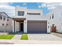 Modern two-story home boasts clean lines, a two-car garage, and contemporary curb appeal at 10253 E Ursula Ave, Mesa, AZ 85212