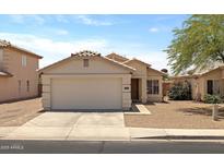 Inviting single-story home featuring a two-car garage and neutral-colored exterior at 11921 W Flores Dr, El Mirage, AZ 85335