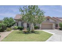 Charming single-story home with lush front lawn and mature landscaping at 1210 W Betty Elyse Ln, Phoenix, AZ 85023