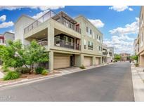 Contemporary three-story condo building with multiple balconies and attached garages at 1250 N Abbey Ln # 206, Chandler, AZ 85226