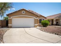 Charming single-story home featuring a two-car garage and desert landscaping under a clear blue sky at 15805 W Morning Glory St, Goodyear, AZ 85338