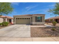 Charming single-story home with a two-car garage and neutral stucco exterior, complemented by desert landscaping at 19951 W Wilson St, Buckeye, AZ 85326