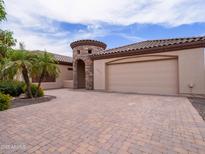 Charming single-story home with a unique stone tower entrance and a spacious brick driveway at 20439 E Palomino Dr, Queen Creek, AZ 85142